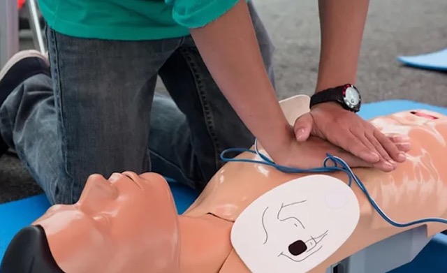 Une personne effectuant un massage cardiaque sur un mannequin lors d'une formation